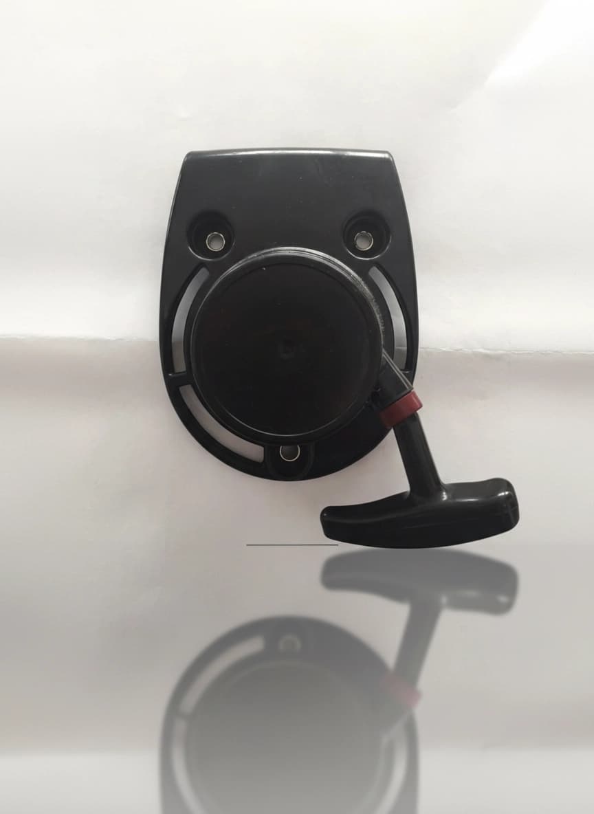Recoil starter assembly for GX35 engine, showing pull cord and housing.